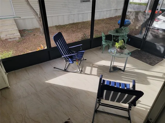 a backyard of a house with barbeque oven table and chairs