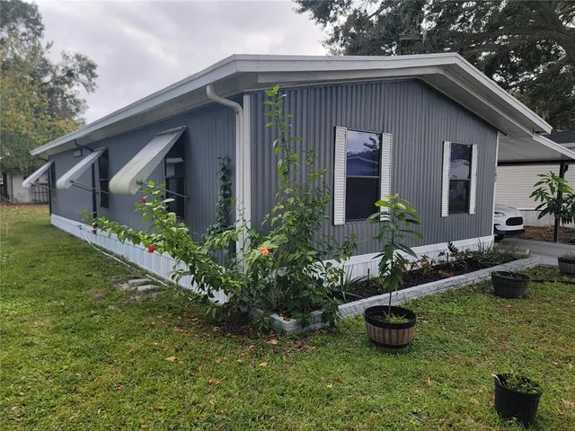 a front view of house with yard and outdoor seating