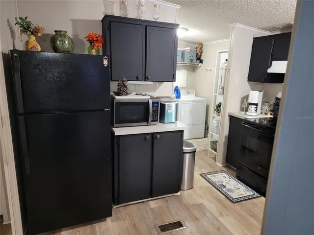 a kitchen with stainless steel appliances a refrigerator stove and microwave