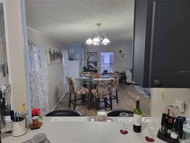a view of a dining room with furniture and chandelier