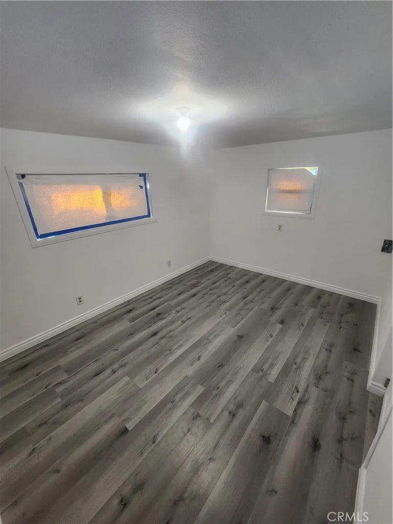 3319 Avalon Street, Unit 78 Riverside, CA 92509 - Photo 17 of 37 an empty room with wooden floor and windows