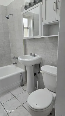 a white toilet sitting next to a bathroom sink