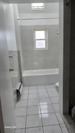 a bathroom with a bathtub and toilet