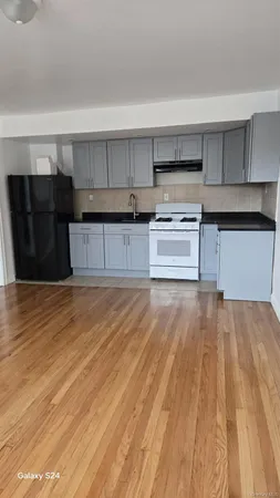 a kitchen with granite countertop a refrigerator and a stove
