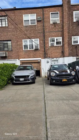 a car parked in front of a brick house
