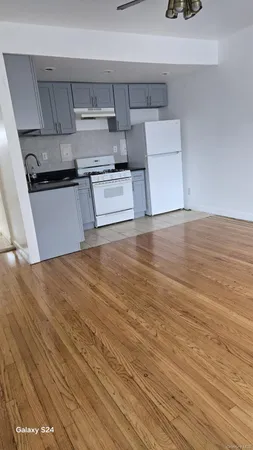 a kitchen with wooden floors and appliances