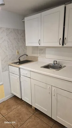 a kitchen with white cabinets