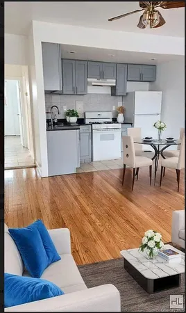 a living room with stainless steel appliances kitchen island granite countertop furniture and a kitchen view