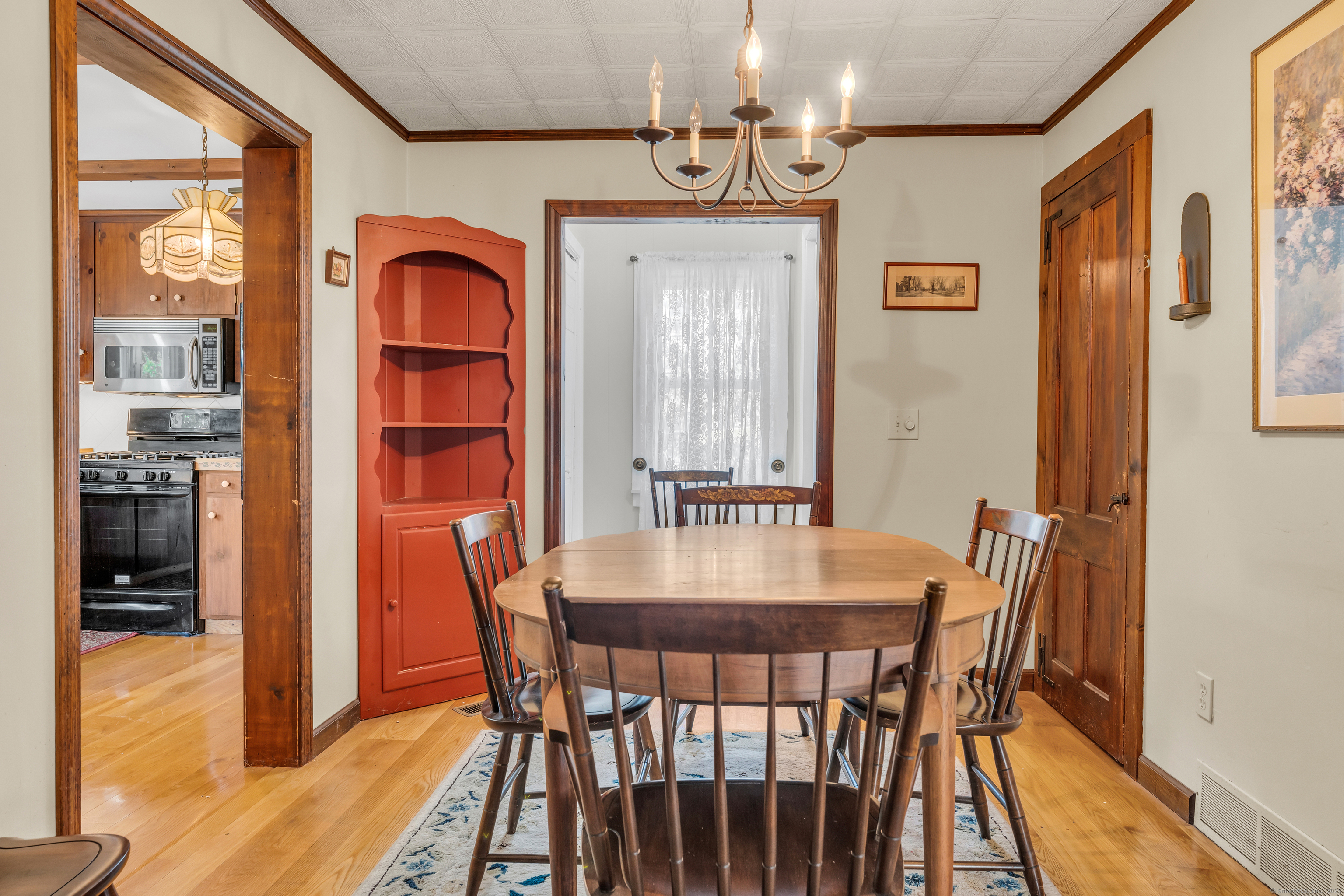 13 Waterside Lane Clinton, CT 06413 - Photo 18 of 40 a dining room with furniture a chandelier and wooden floor