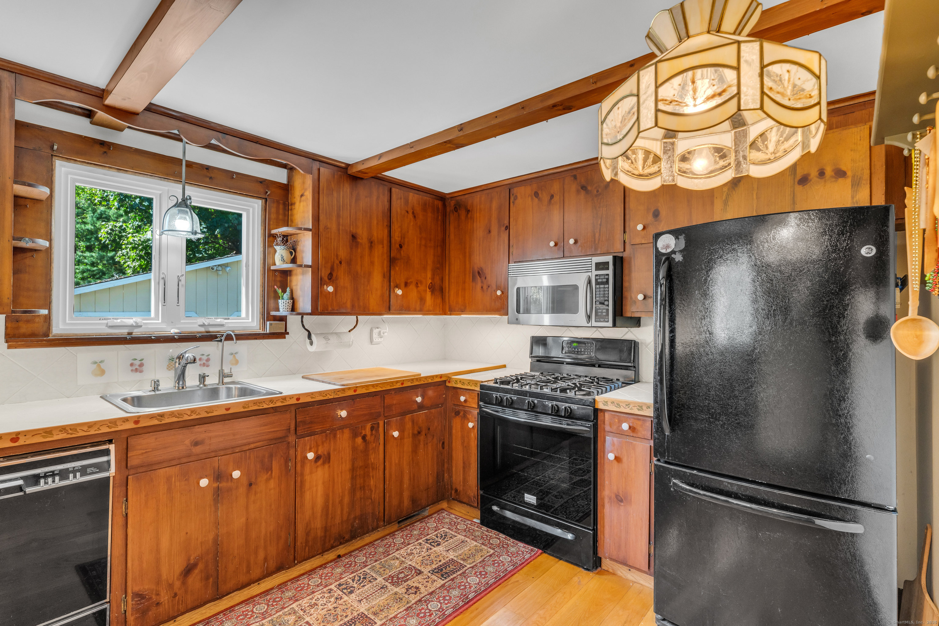 13 Waterside Lane Clinton, CT 06413 - Photo 24 of 40 a kitchen with stainless steel appliances granite countertop a refrigerator and a sink