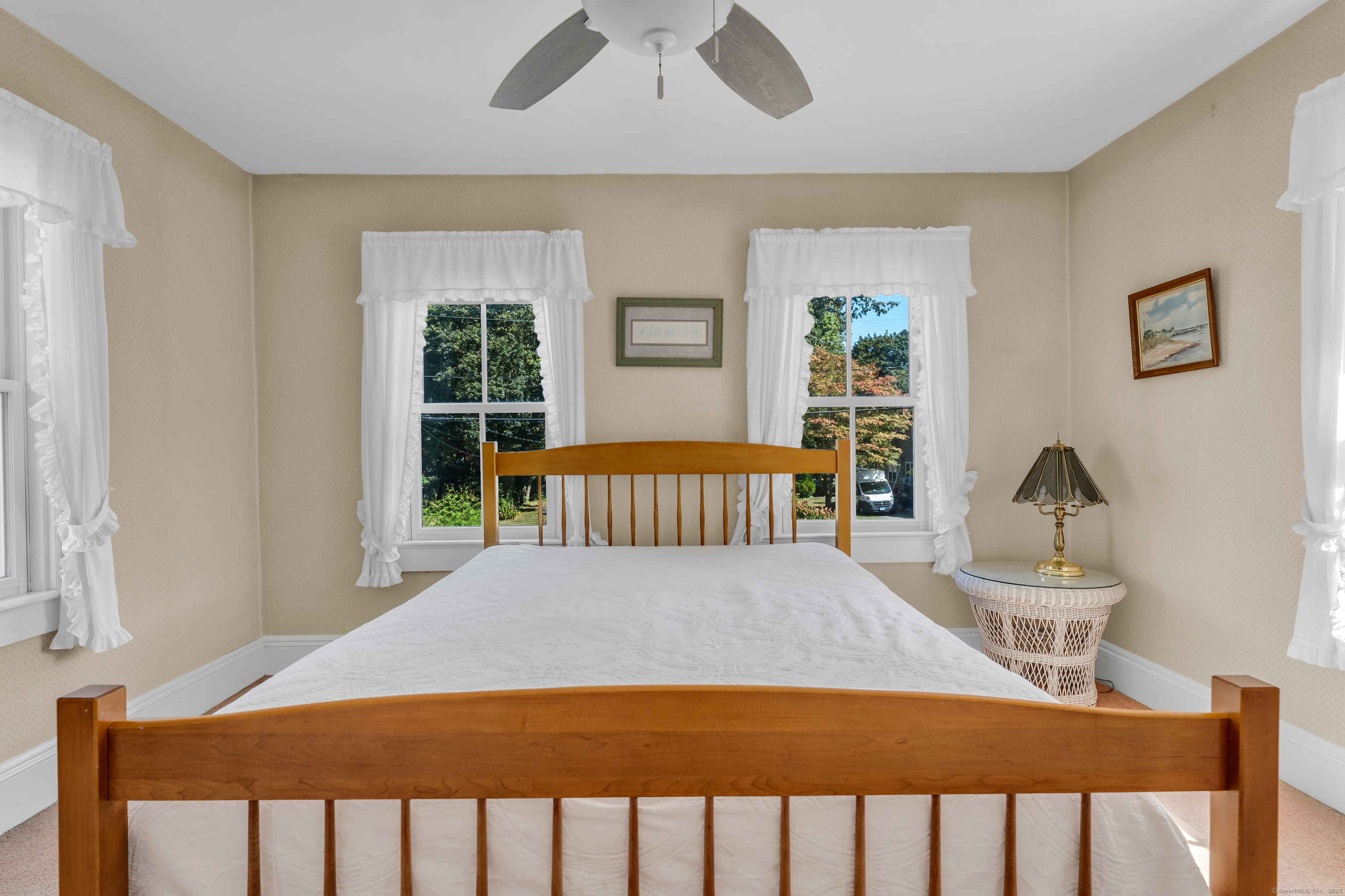 13 Waterside Lane Clinton, CT 06413 - Photo 28 of 40 a bedroom with a bed and a table in it