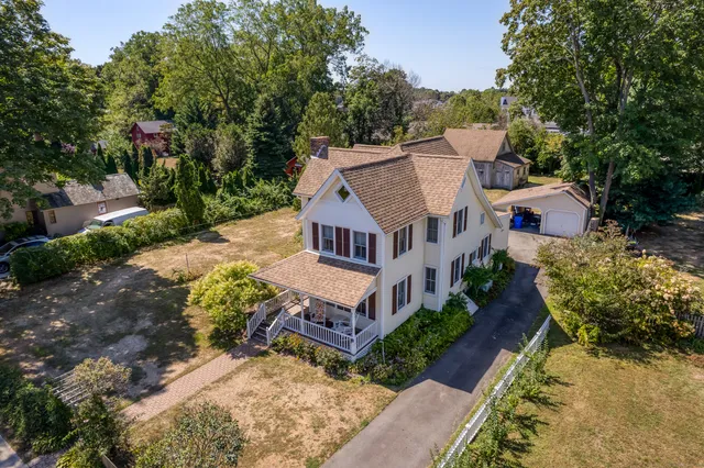 an aerial view of a house with a yard