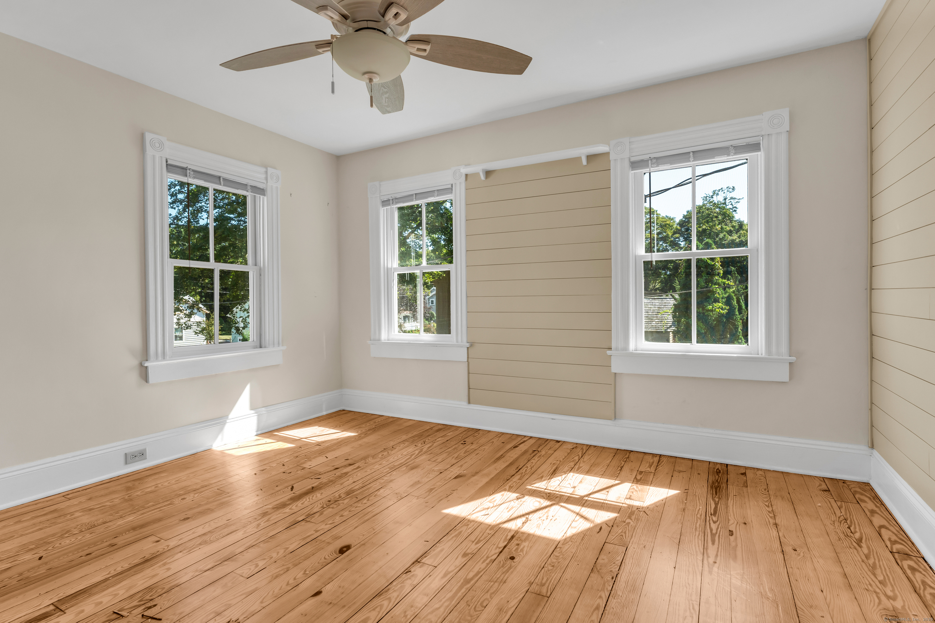 13 Waterside Lane Clinton, CT 06413 - Photo 30 of 40 a view of an empty room with wooden floor and a window