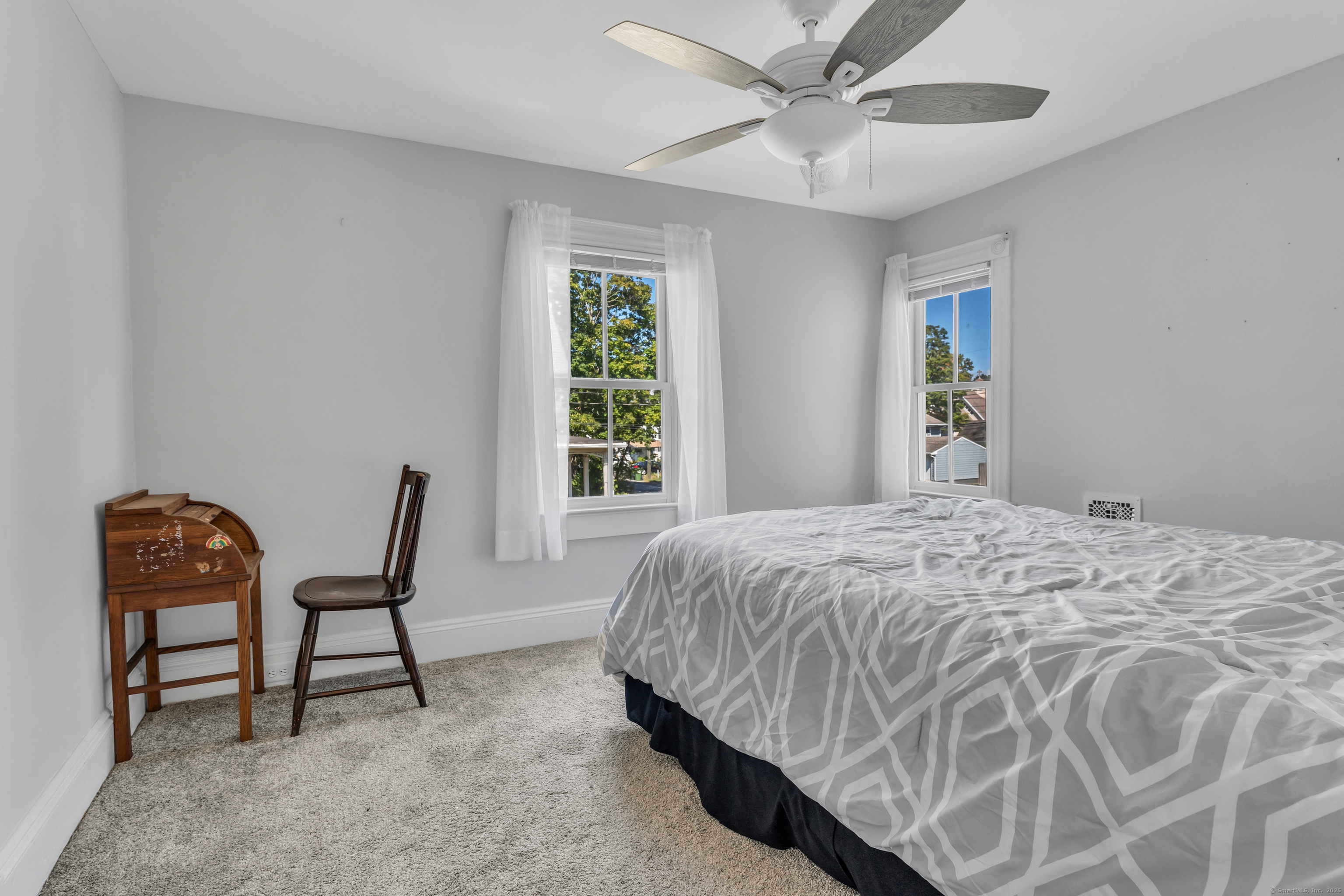 13 Waterside Lane Clinton, CT 06413 - Photo 31 of 40 a bedroom with a bed and chair