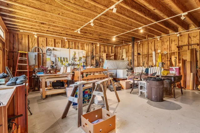 a view of a patio with couches and chairs with wooden floor