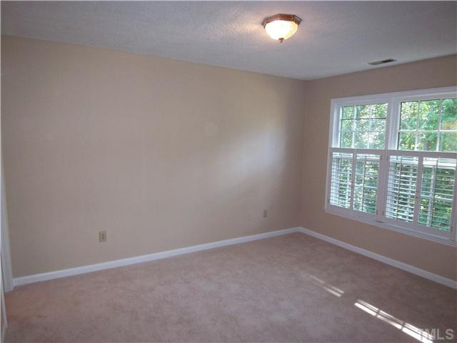 118 Timber Ridge Drive Durham, NC 27713 - Photo 6 of 12 Master bedroom windows overlook back yard trees and has three closets! Plantation shutters also found here! Master Bedroom