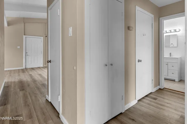 a view of a hallway with wooden floor
