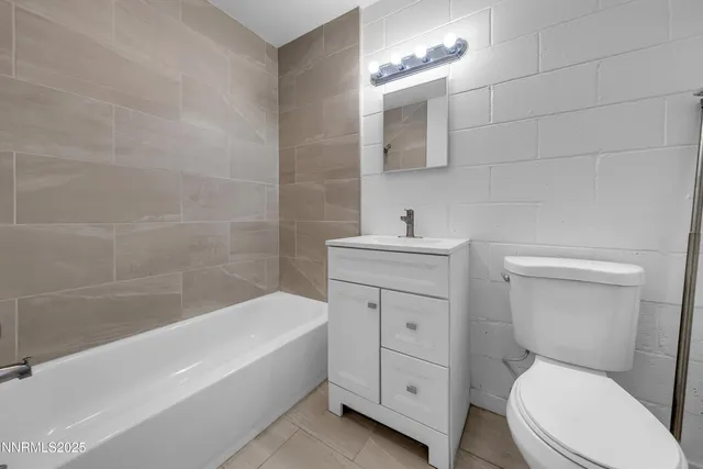 a bathroom with a sink a toilet and bathtub