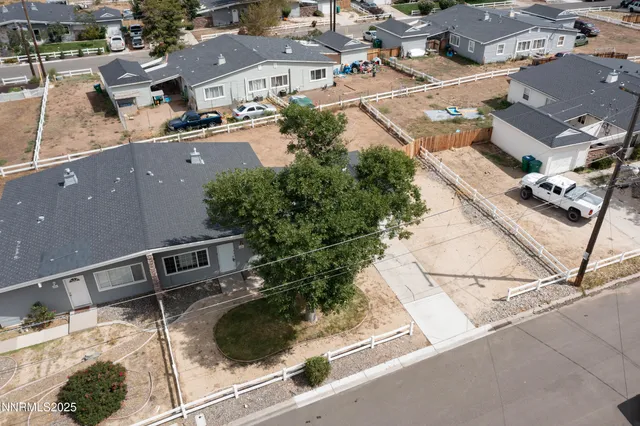 an aerial view of residential houses with outdoor space