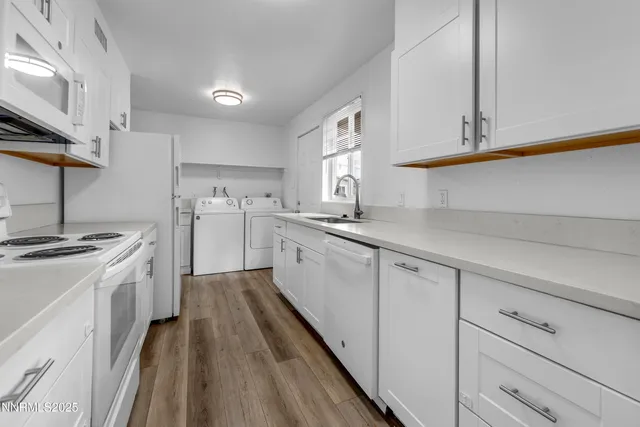 a kitchen with white cabinets and white appliances