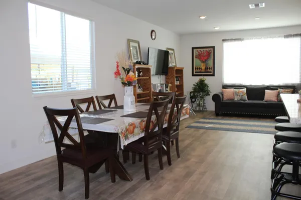 a view of a dining room with furniture and wooden floor