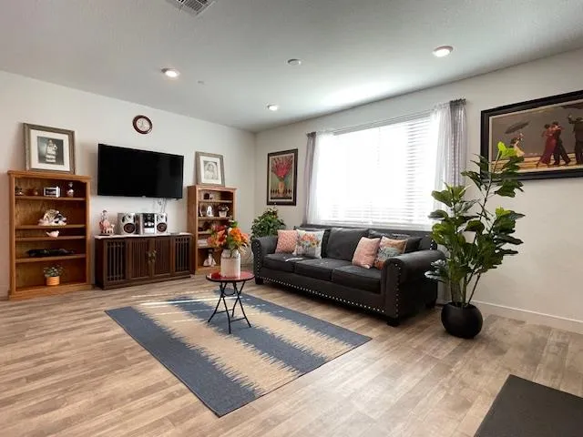 a living room with furniture and a flat screen tv