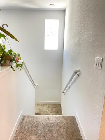 a spacious bathroom with a granite countertop sink a large mirror and shower