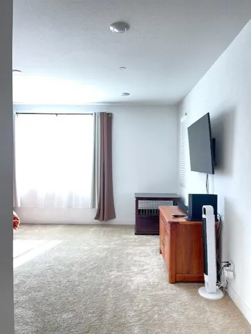 a view of a kitchen with kitchen island granite countertop wooden cabinets and sink
