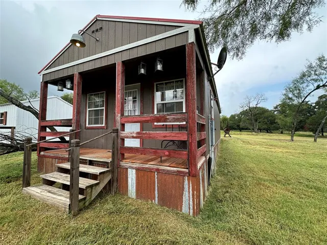 a view of a house with backyard porch and sitting area