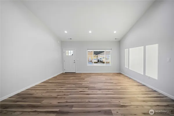 a view of an empty room and wooden floor