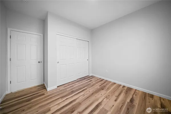 a view of a room with wooden floor