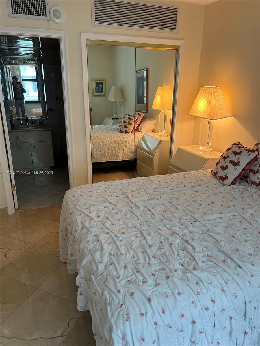 9801 Collins Avenue, Unit 17J Bal Harbour, FL 33154 - Photo 13 of 34 a bedroom with a bed and window