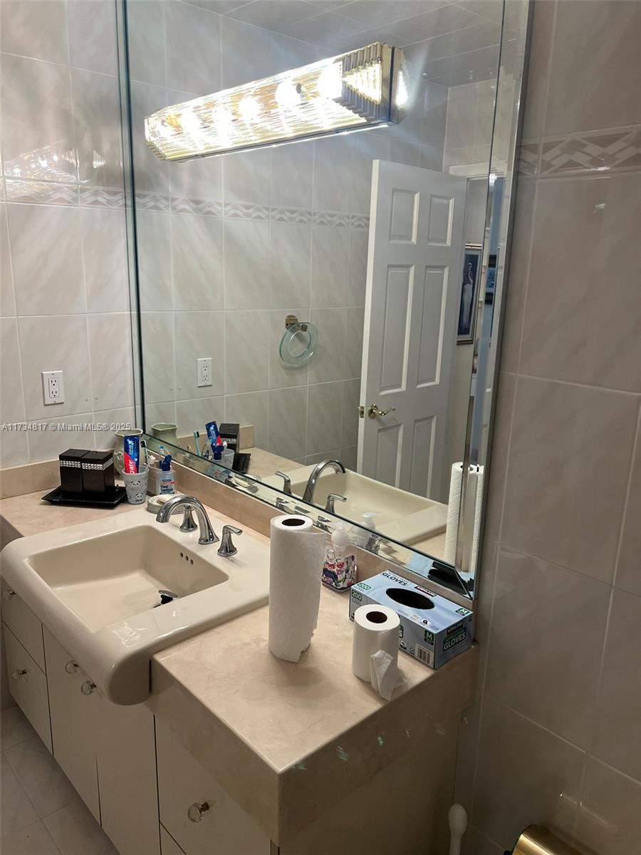 9801 Collins Avenue, Unit 17J Bal Harbour, FL 33154 - Photo 20 of 34 a bathroom with a sink and mirror
