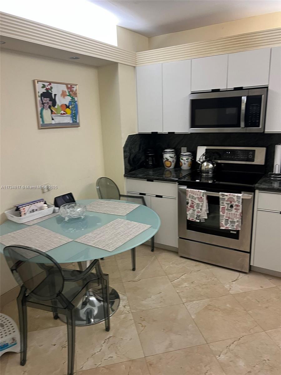 9801 Collins Avenue, Unit 17J Bal Harbour, FL 33154 - Photo 24 of 34 a kitchen with a cabinets appliances and a counter top space