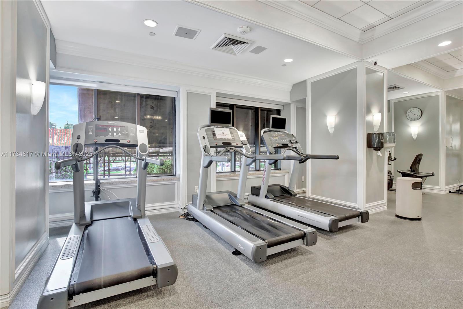 9801 Collins Avenue, Unit 17J Bal Harbour, FL 33154 - Photo 29 of 34 a room with gym equipment and a table