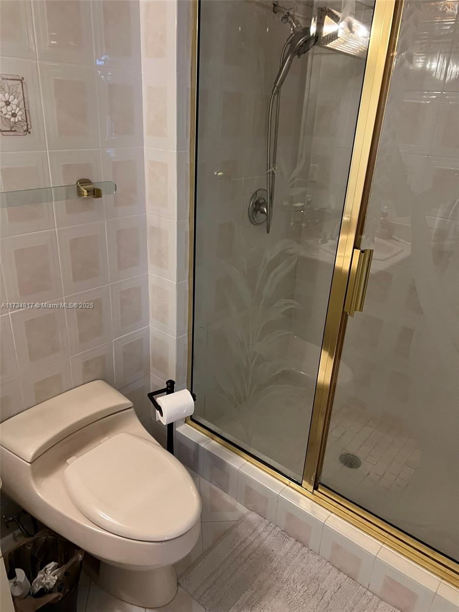 9801 Collins Avenue, Unit 17J Bal Harbour, FL 33154 - Photo 8 of 34 a bathroom with a sink and a mirror