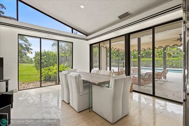 swimming pool view with a seating space and garden view