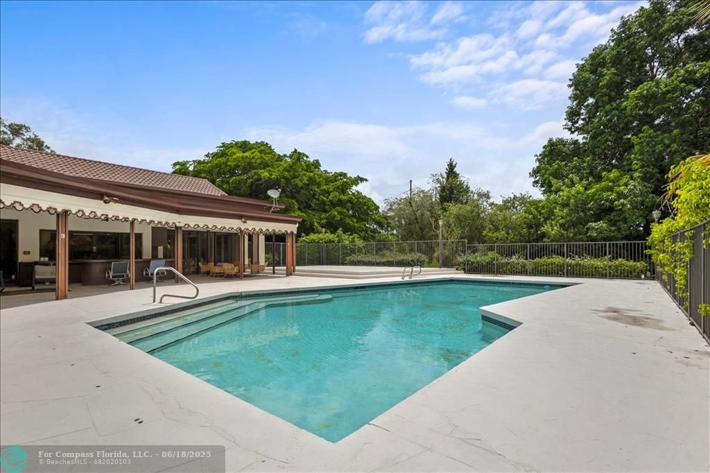 5304 Woodlands Boulevard Tamarac, FL 33319 - Photo 18 of 57 swimming pool view with a seating space and garden view