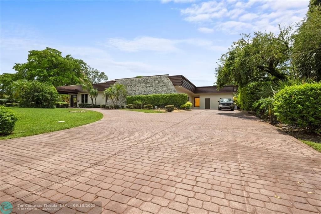 5304 Woodlands Boulevard Tamarac, FL 33319 - Photo 2 of 57 a pathway of a house with a yard