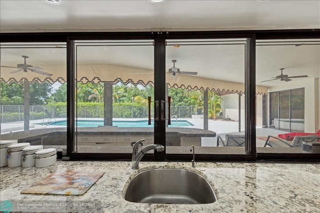 5304 Woodlands Boulevard Tamarac, FL 33319 - Photo 23 of 57 a kitchen with a large window and a sink
