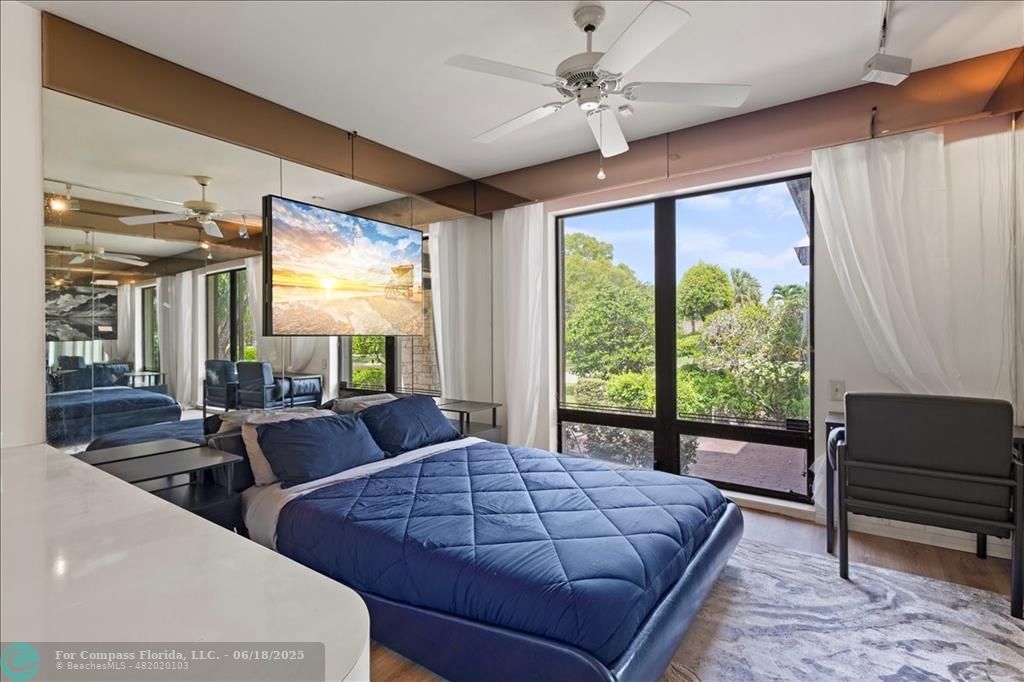 5304 Woodlands Boulevard Tamarac, FL 33319 - Photo 24 of 57 a bedroom with a large bed and a large window