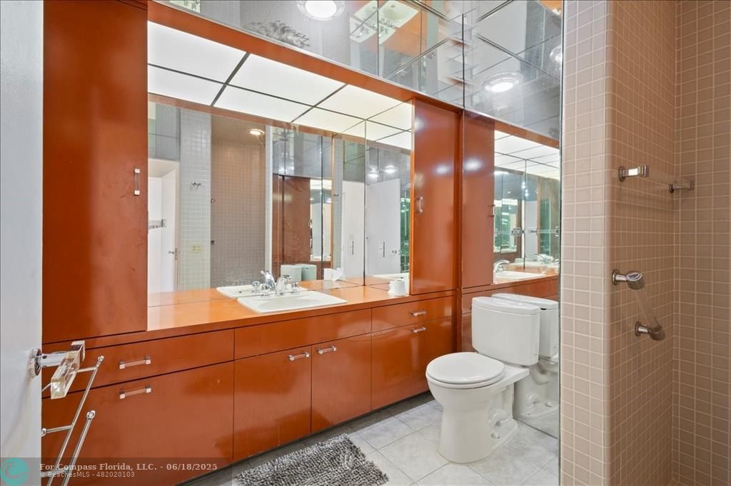 5304 Woodlands Boulevard Tamarac, FL 33319 - Photo 26 of 57 a bathroom with a toilet sink and mirror