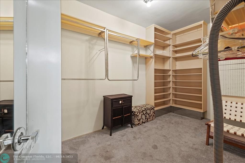 5304 Woodlands Boulevard Tamarac, FL 33319 - Photo 35 of 57 a view of walk in closet with clothes and shoes