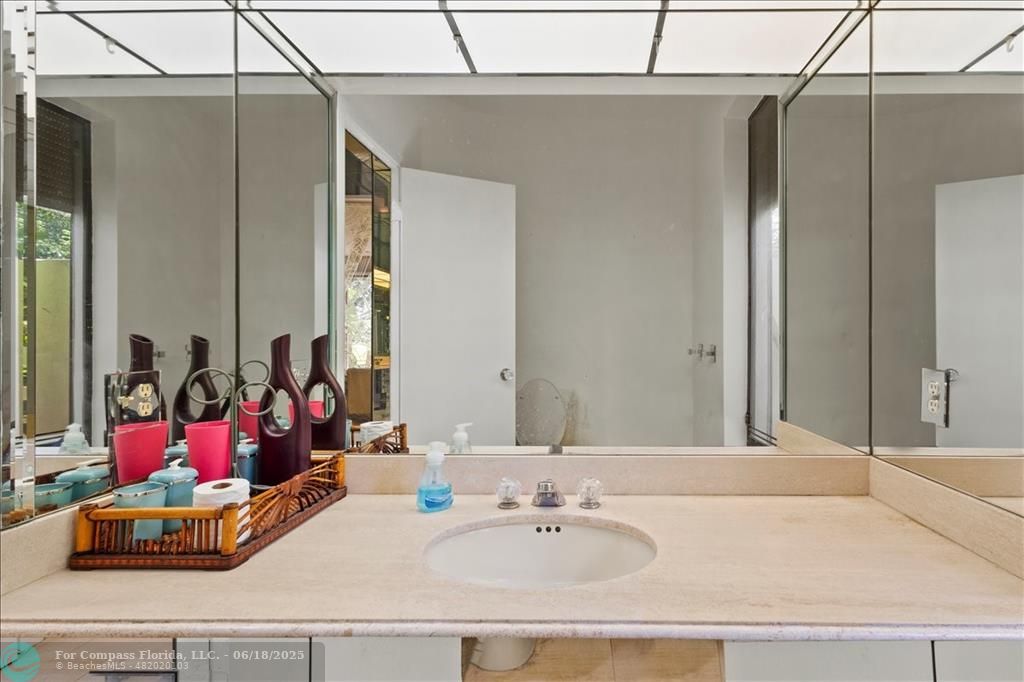 5304 Woodlands Boulevard Tamarac, FL 33319 - Photo 38 of 57 a bathroom with a tub sink and mirror