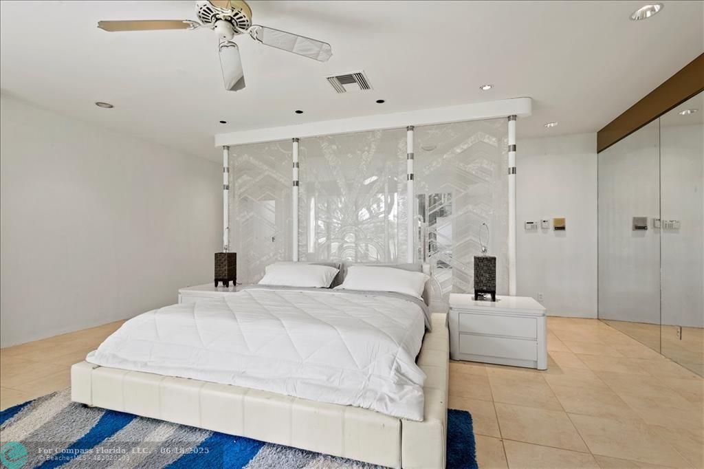 5304 Woodlands Boulevard Tamarac, FL 33319 - Photo 40 of 57 a spacious bedroom with a bed and a chandelier