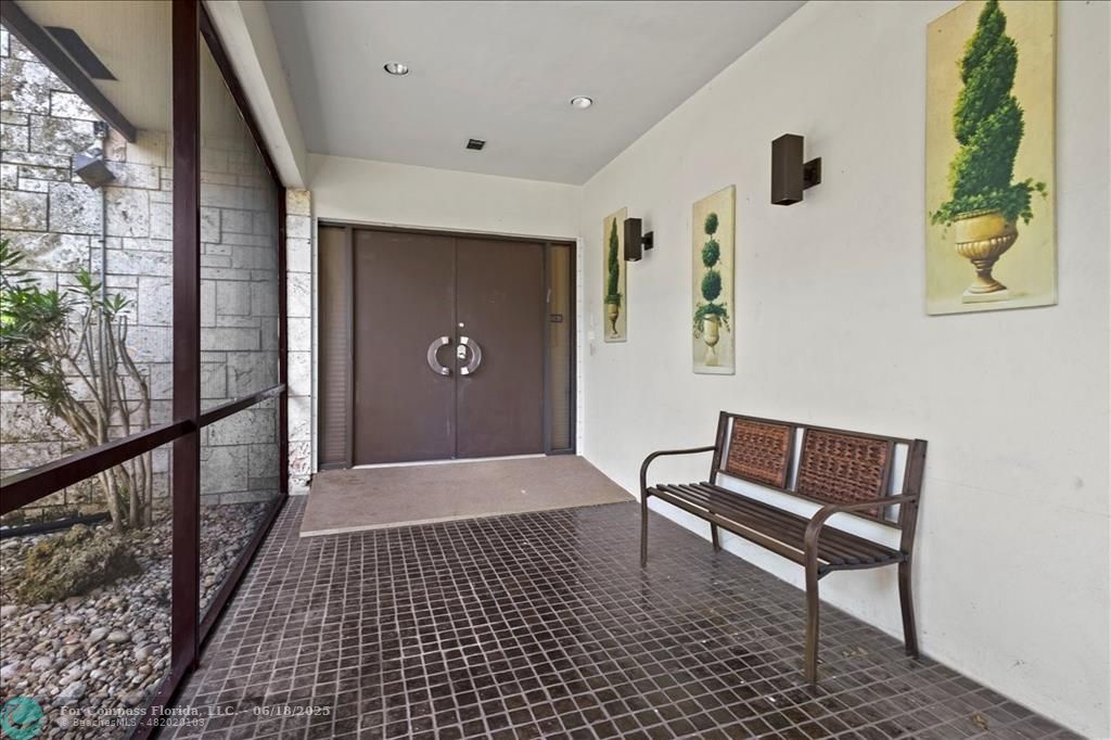 5304 Woodlands Boulevard Tamarac, FL 33319 - Photo 4 of 57 a view of a hallway with wooden floor and a potted plant