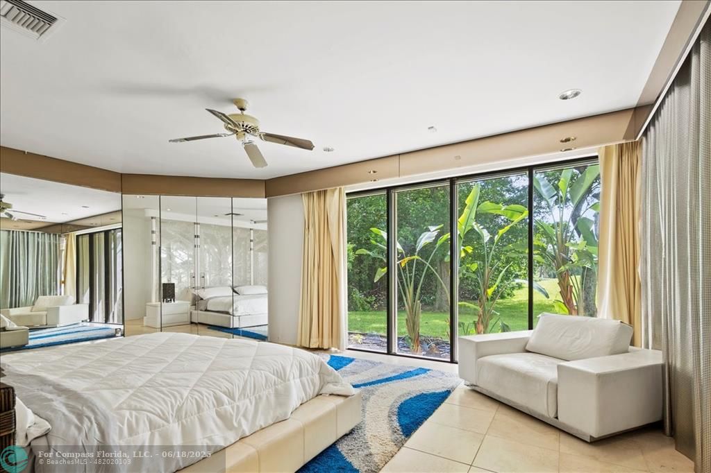 5304 Woodlands Boulevard Tamarac, FL 33319 - Photo 41 of 57 a bedroom with a bed couch and large windows