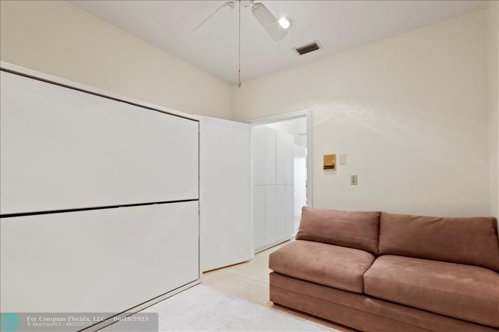 5304 Woodlands Boulevard Tamarac, FL 33319 - Photo 42 of 57 a living room with a couch and a ceiling fan