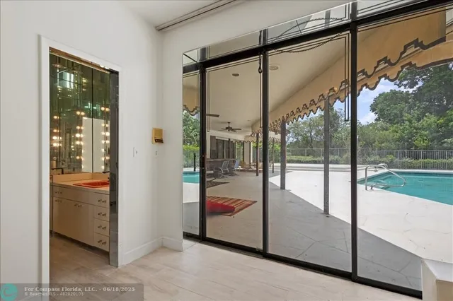 a view of a room that has a window and a bathroom