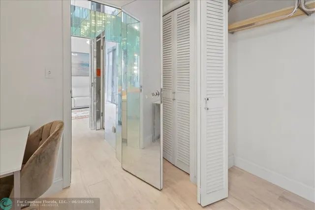 a living room with furniture a flat screen tv and a large window